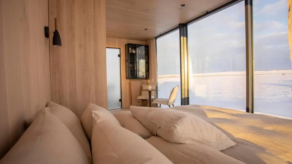 Bungalow Deluxe at AURA Retreat Iceland, with the double bed facing the picture window